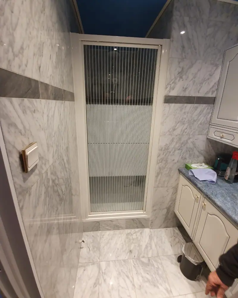 Douche carrelée effet marbre avec paroi vitrée
