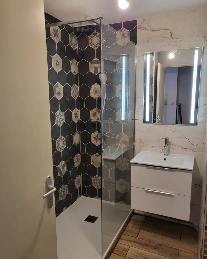 Douche à l’italienne et meuble vasque dans une salle de bain réalisée par Saki Plomberie